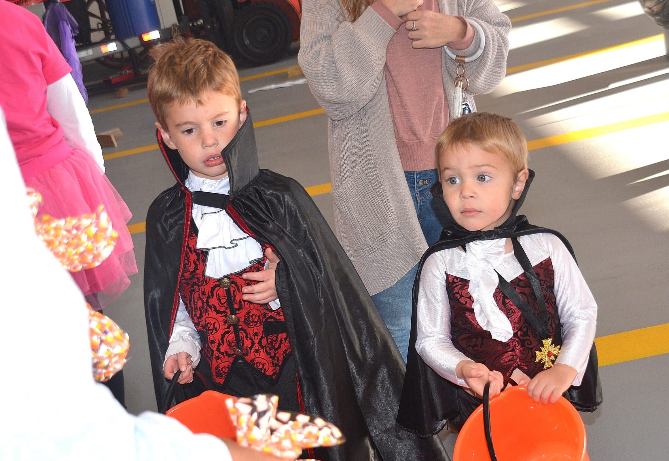 Costumed as the Dracula brothers, the Shiver brothers – Jackson, 5, and Beckett, 3 – get treats while marching past judges and go on to win scariest costume in their age category.