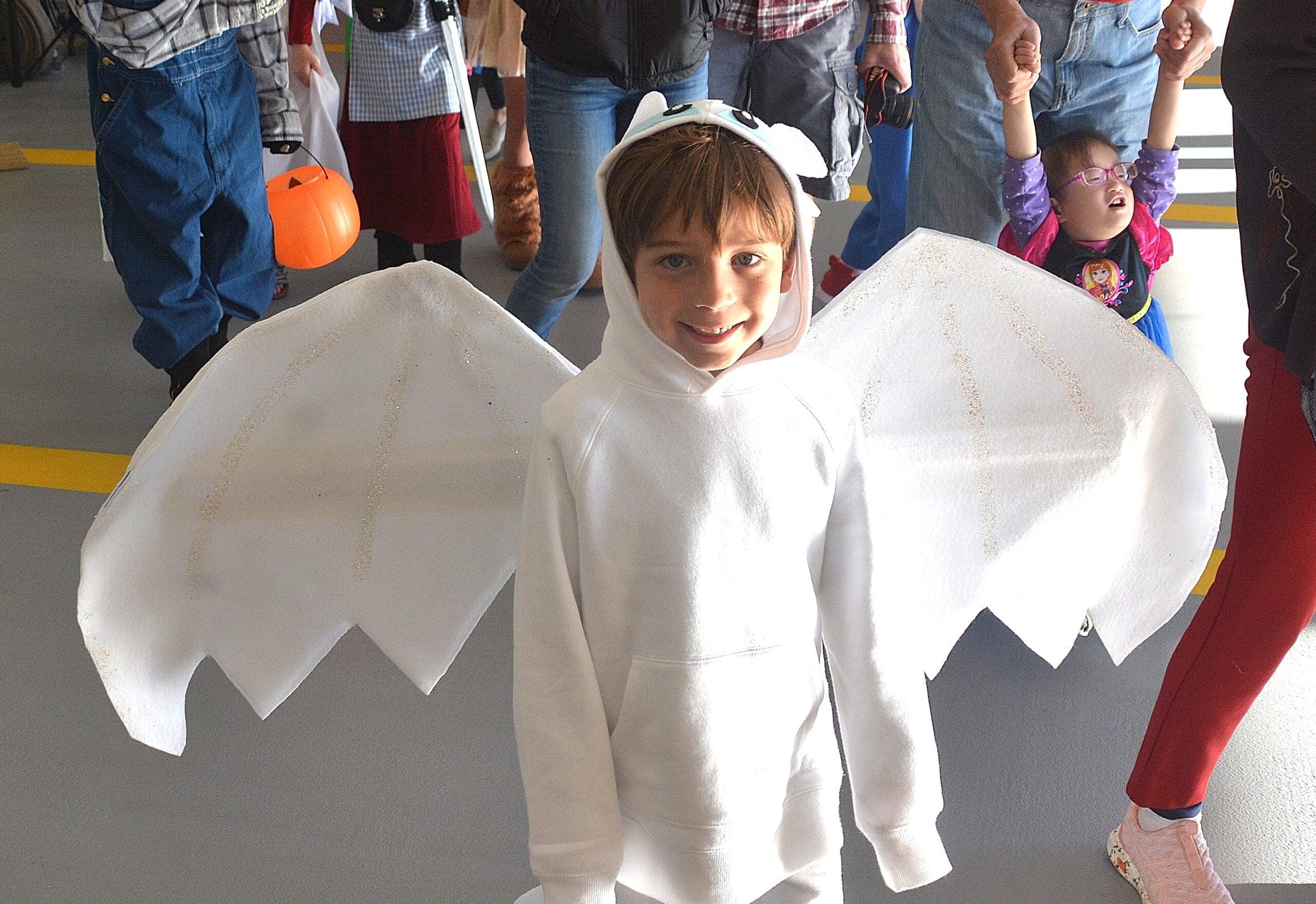 Costumed as Light Fury from the animated film “How to Train Your Dragon,” Max Sorrentino, 5, marches past judges and ultimately wins cutest costume with his brother Jack, 8.