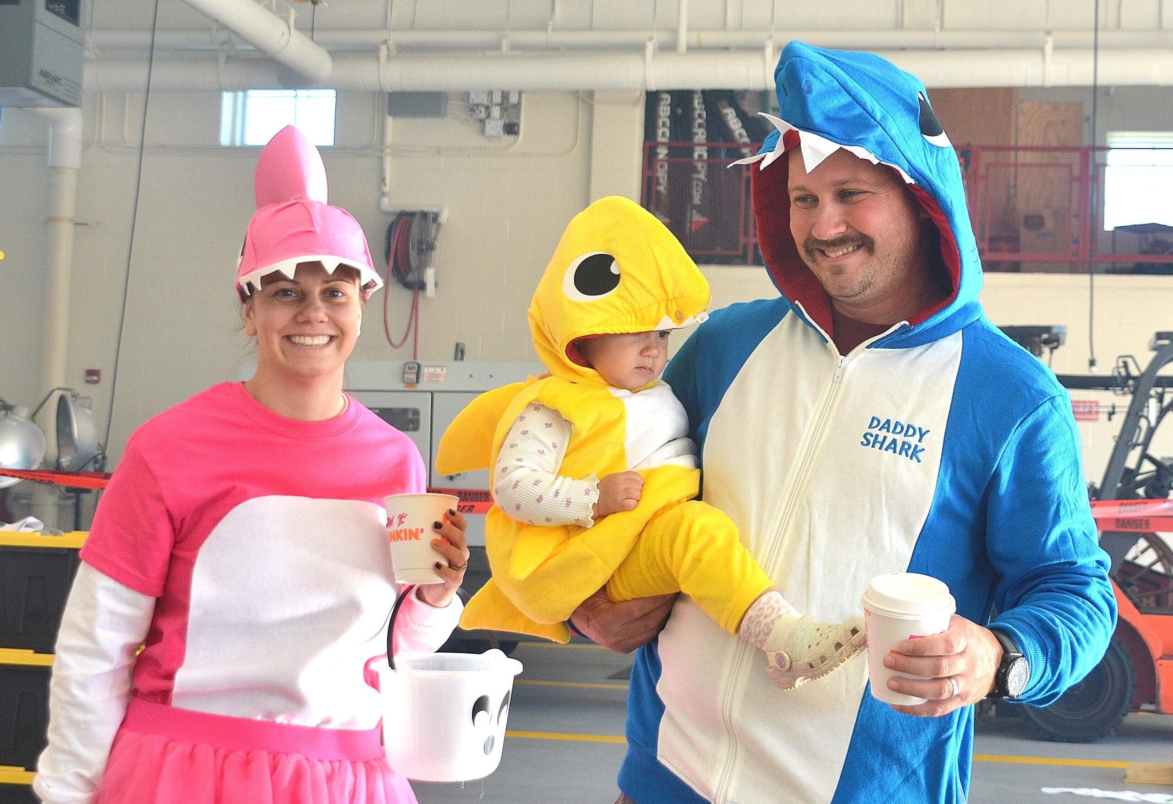 Costumed as sharks, the Kendall family – (l to r) Nekelle, Camryn, 18 months, and Nate – complete the Halloween Parade.