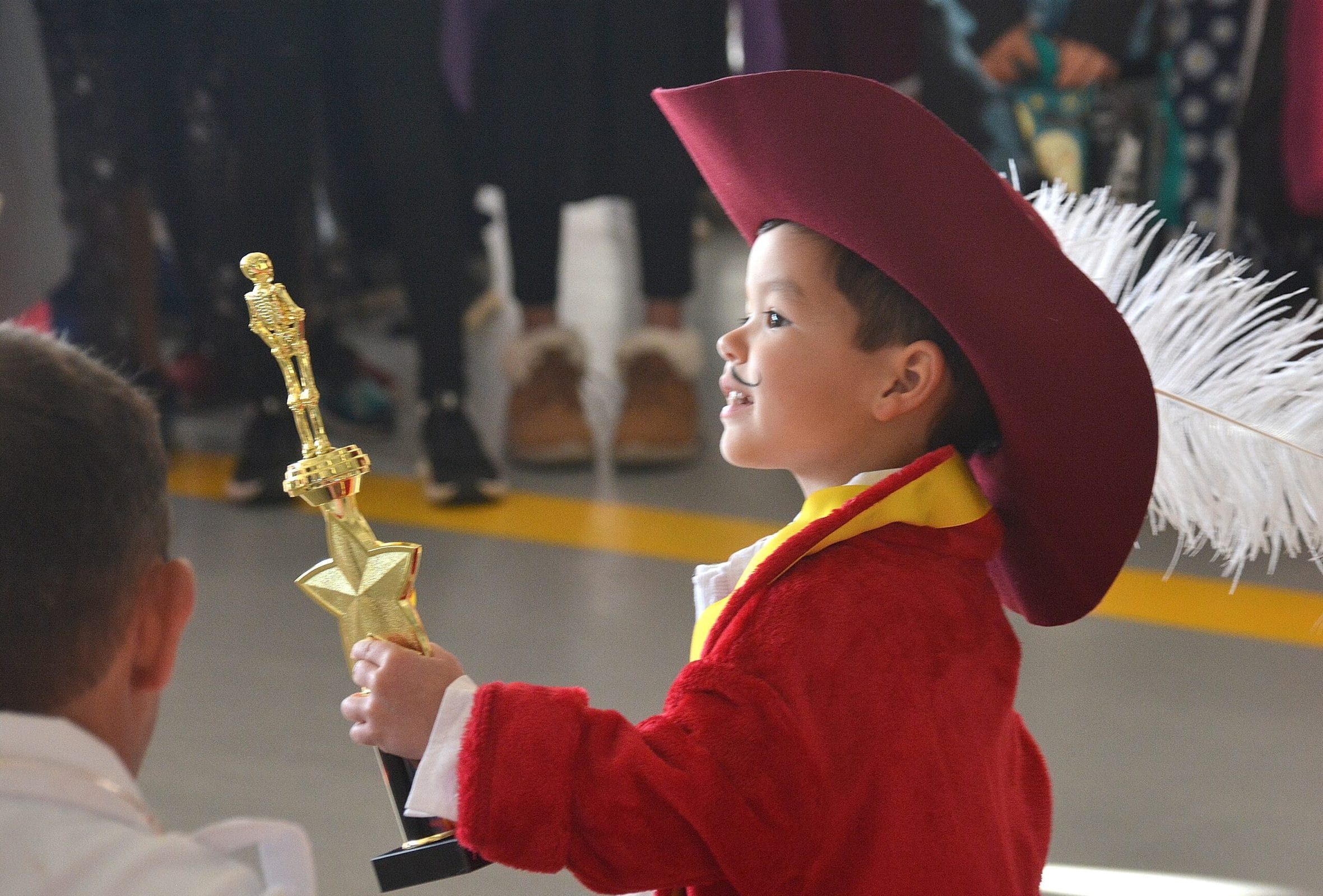 Dominic Rosa, 3, costumed as Captain Hook, accepts the trophy for most original costume runner-up in his age category. Joining him in the parade were his mother Kaite as Peter Pan and father Miguel as Mr. Smee. (Photo/Ed Karvoski Jr.)