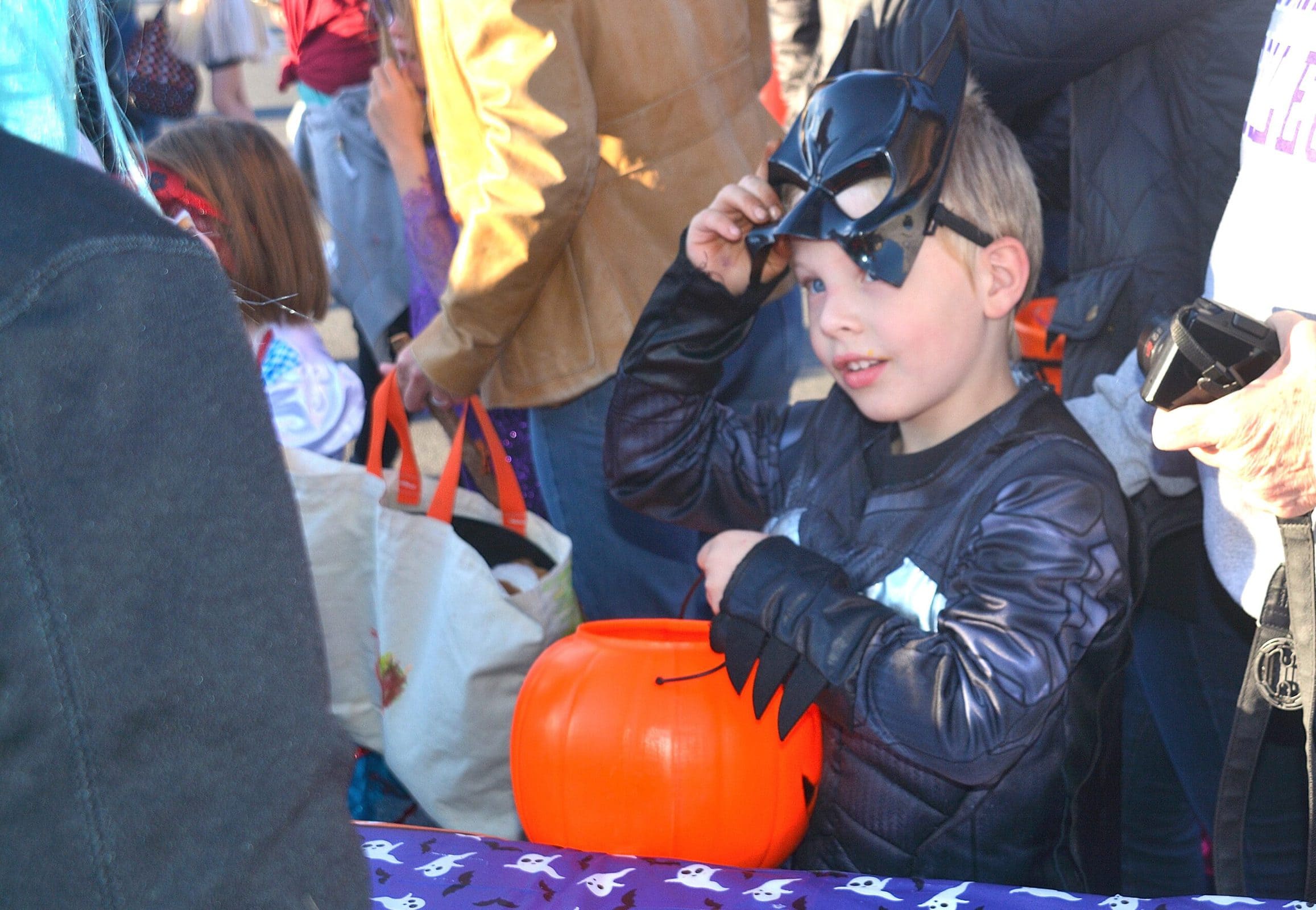 Cameron Wood, 5, costumed as Batman, thanks members of Friends of Southborough Recreation for treats at the Trunk or Treat.