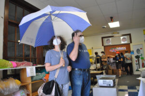 Visitors to the Beal School furniture sale in Shrewsbury, Oct. 16, check out with an umbrella and a handful of other purchases.
