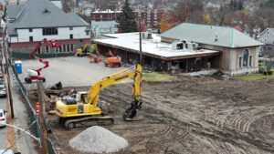 Excavators clear and level land around the existing footprint of the Marlborough Public Library as renovation work continues. (Photo/Tami White)