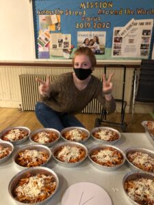 Abby Maston poses for a photo while preparing pasta dinners for take-out as part of St. Stephen Lutheran Church’s recent outreach partnership with Cathedral in the Night in Northampton. 