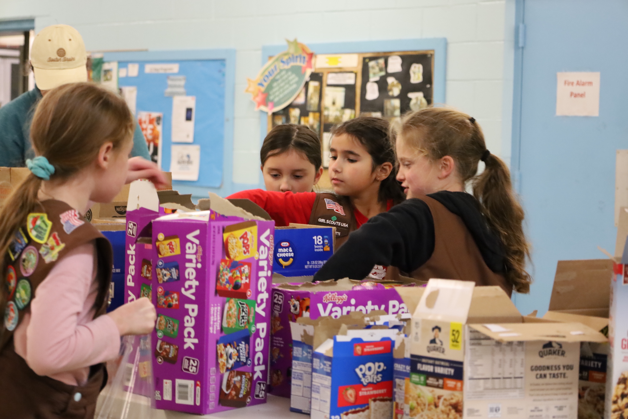 Hudson Girl Scouts pack meals for students in need