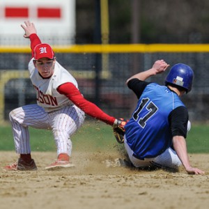 Hudson High School's Ben Palatino (#6, left) tries to tag Leominster High School's Neil O'Connor (#17, right).  O'Connor was safe on the play.