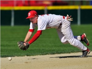 St. John's High School's Tom Petry attempts to stop this hard hit ground ball as it goes through the hole.