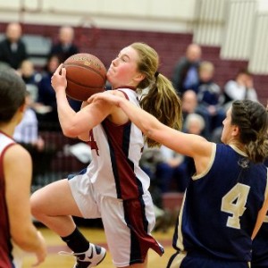 Westborough High School's Carly Flahive (#14, center, with ball) lays it against Shrewsbury High School's Abby Joseph (#4, right). Flahive's teammate Melissa Mastrogiacomo (#24, left) is at the front. 