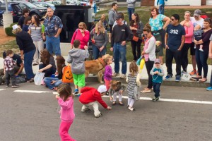 Children along the parade route scramble to pick up candy thrown by parade participants. Photo/Jeff Slovin 