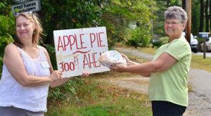 Kate Imhoff and Judith Holmes holding “Apple Pies Ahead” sign. Photo/Submitted