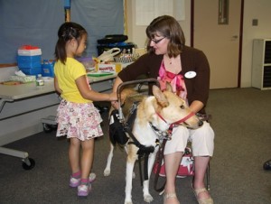Audrey Liu gets up close with Kristin Hartness's service dog, Asha.