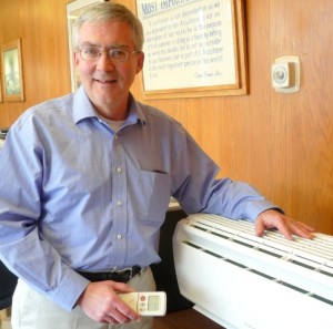 Art Chaves of Coan Heating & Cooling with a ductless air conditioning unit. Photo/Nancy Brumback