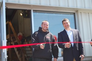 Brett Marcimo (left), the owner of Full Throttle and More and state Rep. Matthew Beaton, R-Shrewsbury, cut the ribbon at the grand opening of the shop. (Photo submitted)