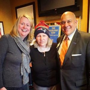 A sad Carolyn Spring (c), a fan of the New York Jets, poses for a photo with fellow Rotary Club of Westborough members (and happy Patriots fans) Betsy Moquin and Steven Sager 