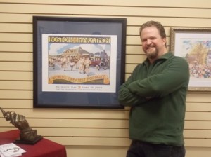 Ed Turner with some of the Boston Marathon artwork now on display at Tatnuck Bookseller