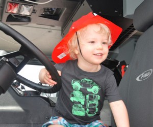Jamieson Field Jr., 2, climbs from the seat of Grafton Fire Department’s Engine 2.