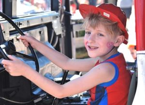 Jack Boggess, 8, steers an Army National Guard Jeep.