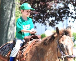 Grafton Little League player Davis McDonald, 6, rides a pony.