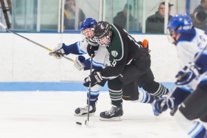 Tanner Jelovcich fights off a Worcester player to keep control of the puck.