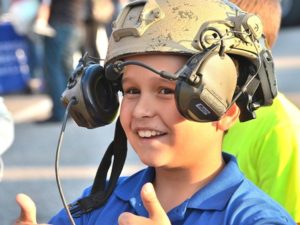 Nathan Baniukiewicz, 8, gives a thumbs up to a helmet displayed by the Central Massachusetts Law Enforcement Council SWAT team.