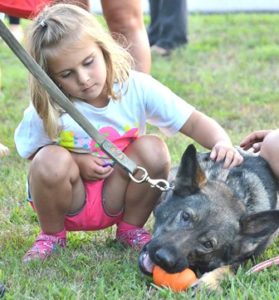 Lucy DeCaire, 4, pets Zita, the Paxton Police Department K-9.