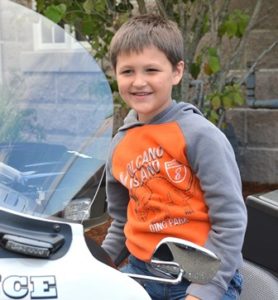 Cole Hunt, 7, takes the seat of a police motorcycle.