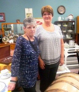 Joan Winterbottom, left, store manager, and Beth Barkley, merchandising manager, in the furniture section of Treasures thrift shop Photo/ Nancy Brumback 