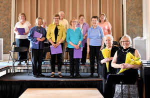 Donna Blanchard, executive director of Apple Tree Arts and director of the Grafton Senior Center Chorus (front, seated) with Elizabeth Mack, accompanist (front, standing) and members of the chorus (front row: Phyllis Bath, Bernadette Warwick, Fran Kuchinsky, June Whitney; (back row) Mary Iram, Carol English, Al Sanborne, Beverly Mara and Paulette Warwick Photo/submitted