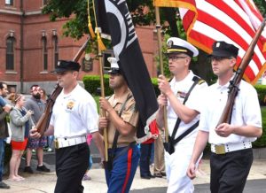 AMVETS Post 208 Color Guard leads the parade past the Town Hall.
