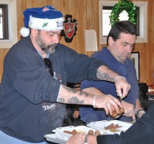 Tim Coughlan and John Lavigne help assemble dinners.