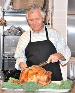 George E. Danis carves a turkey.
