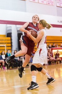 Hudson’s Jen Kallin (white) attempts to steal the ball from Westborough’s Nicole Foster (red) but ends up getting called for a foul.