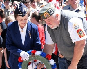 Mary Hazeldine of the Hudson American Legion Auxiliary Post 100 and Commander Bill Rivers of Hudson AMVETS Post 208 lay a wreath at the monument in Liberty Park. 