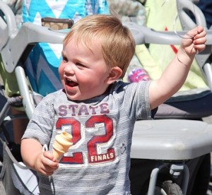 Travis Rickman, almost 2, maneuvers an ice cream cone bubbler in one hand and a balloon in the other.