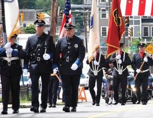 Leading the funeral procession are the color guards of the Hudson Police and Fire Departments. 