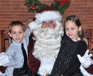 The stylishly dressed McGuire siblings – Cameron, 5, and Makena, 6 – visit Santa Claus at the Hudson Senior Center.