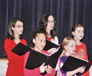 Under the direction of Lisa Schliker, members of the River’s Edge Youth Chorus sing holiday classics.