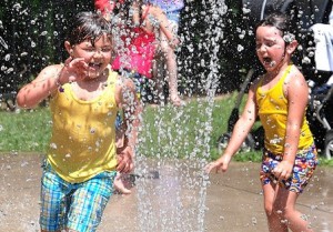 Sarah Brandao, 6, and her sister, Deborah, 3, play together in the Splash Pad.