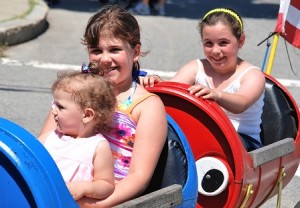 Isabella Fernandes, 21 months, and her sister, Emanuelle, 9, along with Natalie Mollica, 9, ride the trackless train.