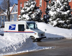 Driving through Wood Square, a postal employee returns to work Jan. 28 after a rare day off from work due to snow Jan. 27.