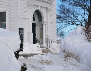 The entrance of the Unitarian Church of Marlborough and Hudson is flanked with piles of snow.