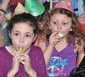 Reese O’Connor, 6, and Caitlin Carvso, 5, toot their horns.