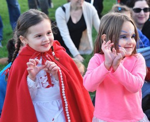 Miming with a song led by Mr. Vic are 3-year-old friends Hazel Shaw, dressed as Little Red Riding Hood, and Addison Monteiro, with her face painted as Elsa of the film “Frozen.” 