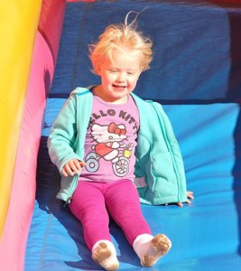 Kylie Henderson, 3, slides down an inflatable slide.