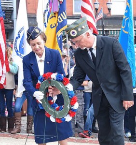 Past President Mary Hazeldine of American Legion Auxiliary Post 100 and Commander Chuck Armstead of AMVETS Post 208 lay a wreath at Liberty Park.