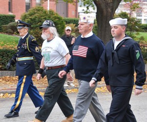 Marching past the Town Hall are (l to r) Richard Bonazzoli, Army veteran of the Korean War; Rick Giroux, Army veteran of the Vietnam War; Al Temple, Army veteran of the Vietnam War; and Patrick Hickey, serving active duty in the Navy.