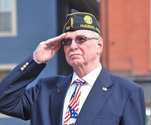 Past Commander Joe Jacobs of American Legion Post 100 salutes as the American flag is risen.