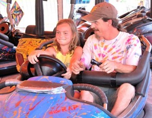 Brooke Patrick, 8, and her father Corey ride a bumper car together.