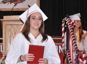 Samantha Sousa steps off the stage with her diploma.