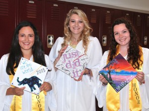 (l to r) Kayla Monteiro, Renee Baker and Lucy Small display their decorated caps.